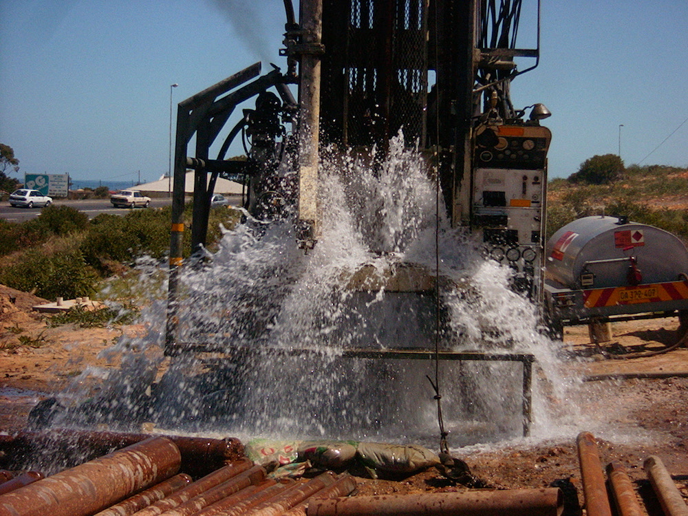 Borehole drilling rig working on a water access project